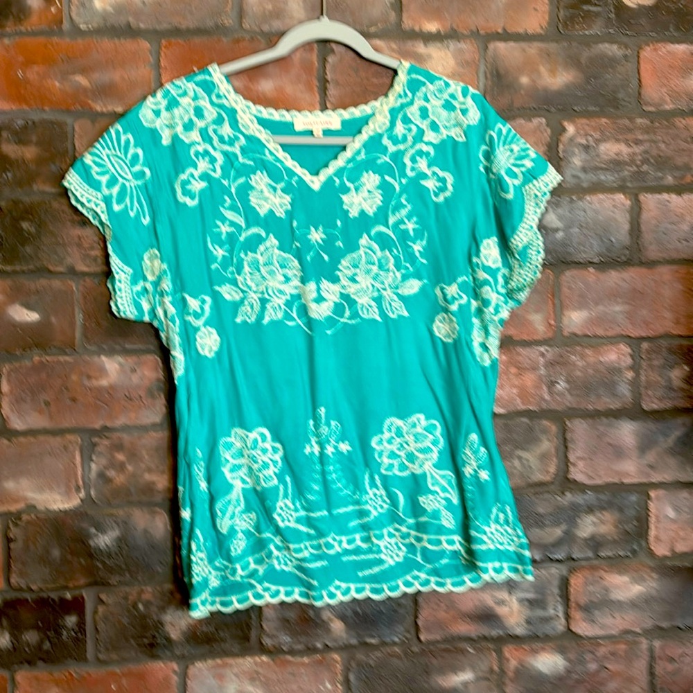 Short sleeve top. Pretty embroidery detail throughout.